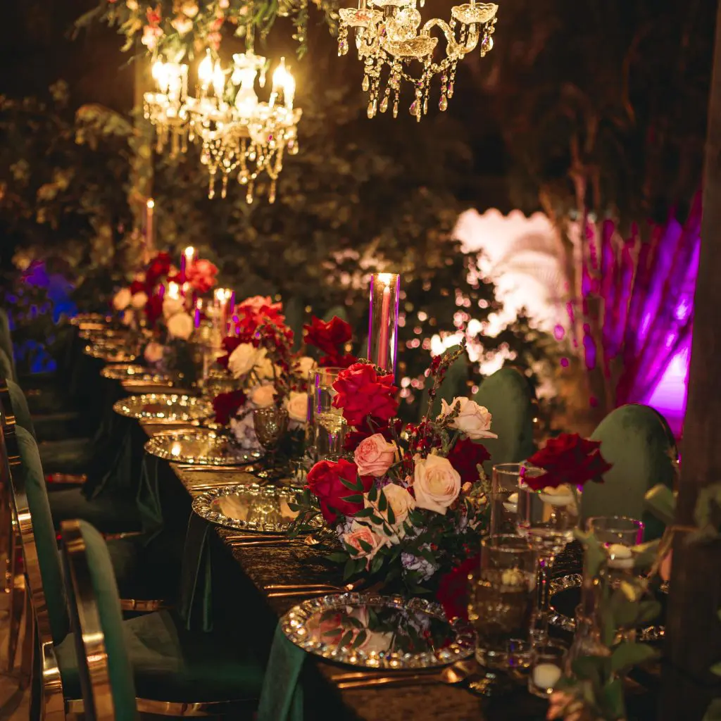 A long table with many flowers and candles