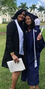 A woman and man in graduation attire standing next to each other.