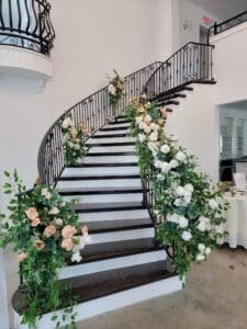 A staircase with flowers on the bottom of it