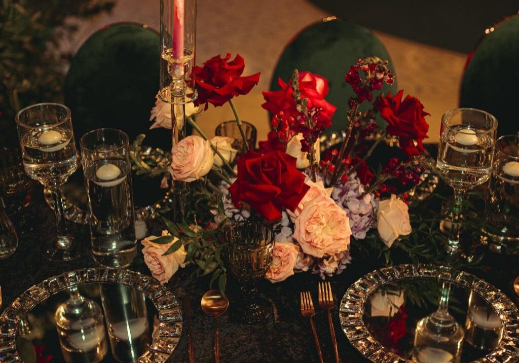 A table set with roses and candles.